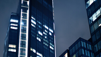 Office building at night, building facade with glass and lights. View with illuminated modern skyscraper. - 757820439