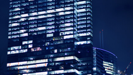 Office building at night, building facade with glass and lights. View with illuminated modern skyscraper. - 757820818