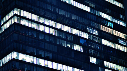 Office building at night, building facade with glass and lights. View with illuminated modern skyscraper. - 757821609