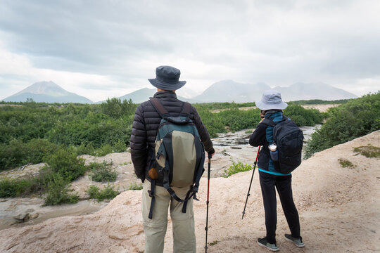 Two people hiking the Valley of Ten Thousand Smokes. Taking photos using smartphone. Katmai National Park and Preserve. Alaska. USA.