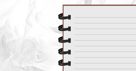 Image of spiral bound lined notebook over scrunched white paper texture
