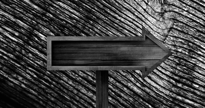 Image of wooden arrow sign over changing wood grain pattern, black and white