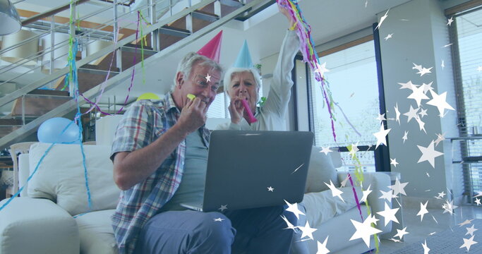 Image of white stars over happy caucasian senior couple making celebration laptop image call