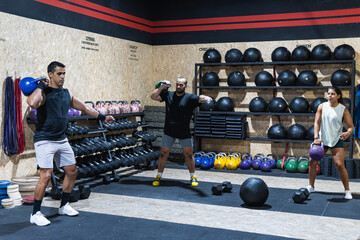 Fitness, weightlifting and kettlebell class for arm workout, exercise or training together at the gym. Active people in sports exercising with kettle weights for healthy cardio endurance or wellness