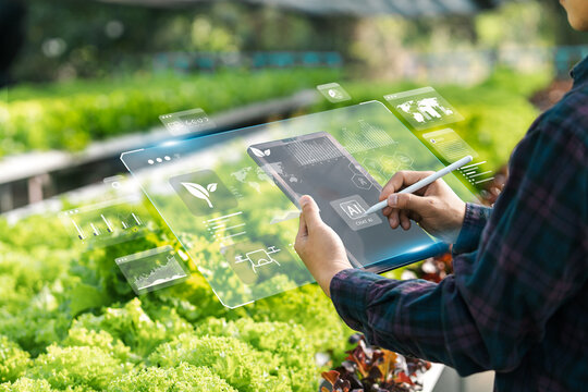 Agricultural technology concept, Ai system. A young man is working on a farm using a tablet controller with innovative technology for a smart farm system.
