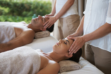Facial, head massage and couple in spa to relax on bed for luxury pamper treatment together in...