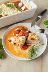 Chicken casserole with feta cheese, tomatoes and herbs 