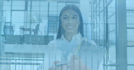 Image of financial data processing and globe over biracial businesswoman in office