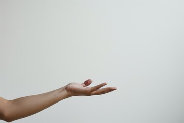 A hand is raised in the air, with the fingers spread wide. Concept of openness and positivity, as if the person is offering something or expressing a welcoming gesture