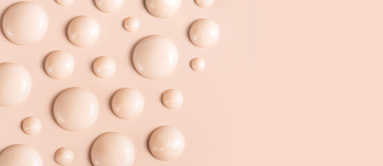cosmetic smears drops of cream texture on beige background