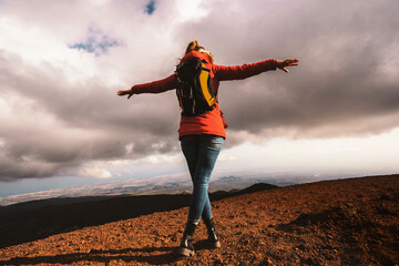 Woman Embracing Freedom on Mountain Summit