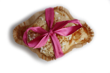 Fototapeta na wymiar Sweet Easter cake named Colomba Pasquale (Easter dove) with pink tied bow isolated on white background. Italian traditional pastry 
