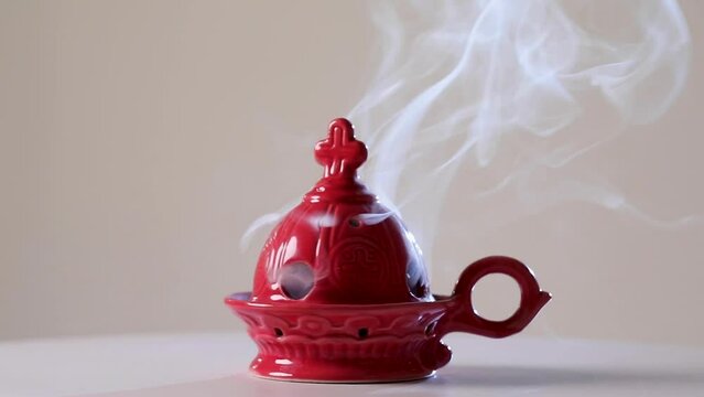 Red censer with burning incense