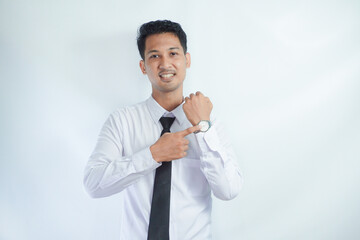 Adult Asian man smiling happy while pointing to his watch