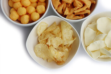 Top view of white ceramic bowls with different kind of chips isolated on white background