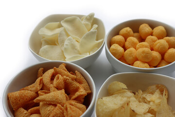 Top view of white ceramic bowls with different kind of chips isolated on white background