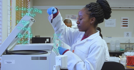 Image of mathematical equations over diverse doctors taking samples