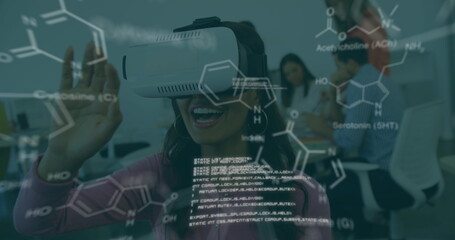 Image of scientific data over biracial woman wearing vr headset in office