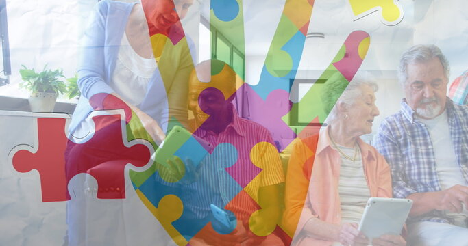Image of colourful puzzle pieces hand over senior friends using electronic devices - Powered by Adobe