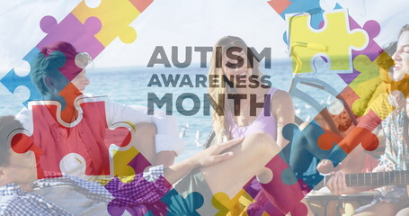 Image of colourful puzzle pieces and autism text over happy friends at summer beach party