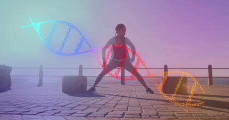 Image of dna strand over biracial woman stretching on promenade