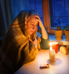 Woman with candles. Power outage in Kyiv