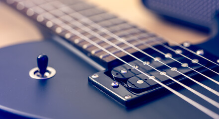Photo of details of an electric guitar close up.