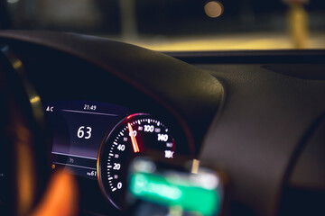 Close-up, car speed indicators in a car at night.