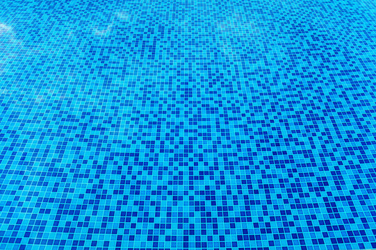 Abstract view of bottom caustics of swimming pool with ripple...