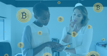 Image of bitcoin symbols over diverse business people in office