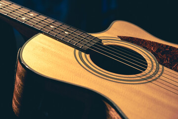 Obraz premium Musical background with acoustic guitar close up.