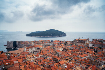 Amazing panoramic view of picturesque Dubrovnik old town, towers, narrow stone streets and buildings with red roofs on Adriatic sea coast, Croatia. - 757870694
