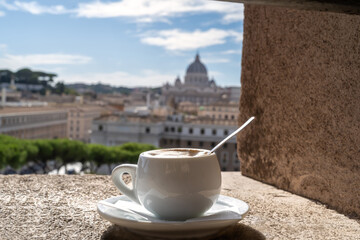 A cup of coffee on the terraces of Sant'Angelo castle overlooking St Peter's Cathedral in Rome, Italy