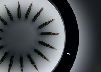 Part Of Perfect Circle Made With Ammunition Cartridges In Circle Of Light
