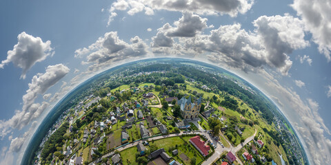 Aerial view from high altitude tiny planet in sky with clouds overlooking old town, urban...