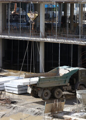 loading concrete blocks onto a truck using a crane at a modern construction site