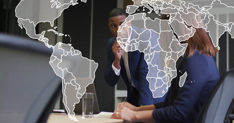 Image of world map over diverse business people in office