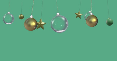 Image of christmas baubles on green background with copy space