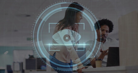 Image of scope scanning with cyber security text over diverse business people working at office