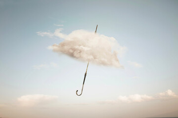 surreal cloud cover of an umbrella flying in the sky, abstract concept