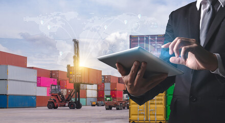 A professional man uses a tablet to manage and track shipping containers, with a futuristic global logistics network overlay...