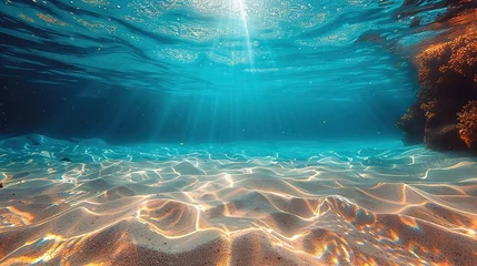 Fototapeten Seabed sand with blue tropical ocean above, empty underwater background with the summer sun shining brightly, creating ripples in the calm sea water © Jennifer