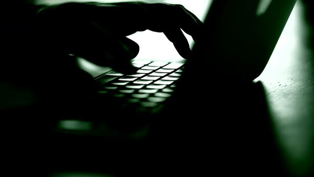 Businessman hands type on laptop keyboard business 4K Hands touch typing on laptop notebook keyboard sit at home office desk working online. Technology and business concept close up side view.