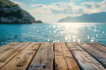 Wooden table top with blurred sparkling sea backdrop 