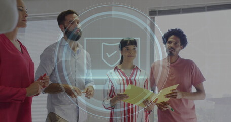Image of scope scanning with cyber security text over diverse business people working at office
