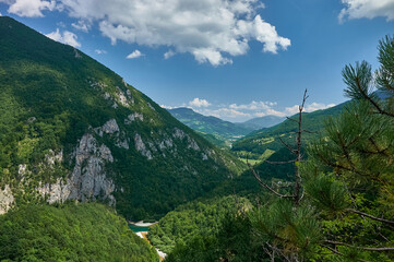 Fototapeta na wymiar Mountains and Tara river. Beautiful panorama mountains of Montenegro. Mountains and forests on the slopes of the mountains.
