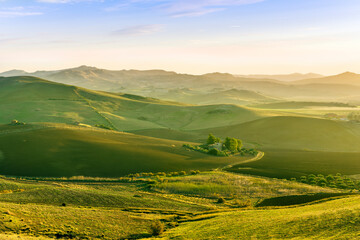 beautiful countryside landscape with green and golden rural hills and mountains with amazing blue...