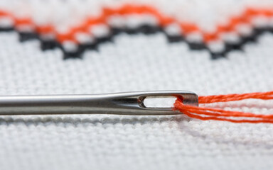 Macro of eyelet and red thread