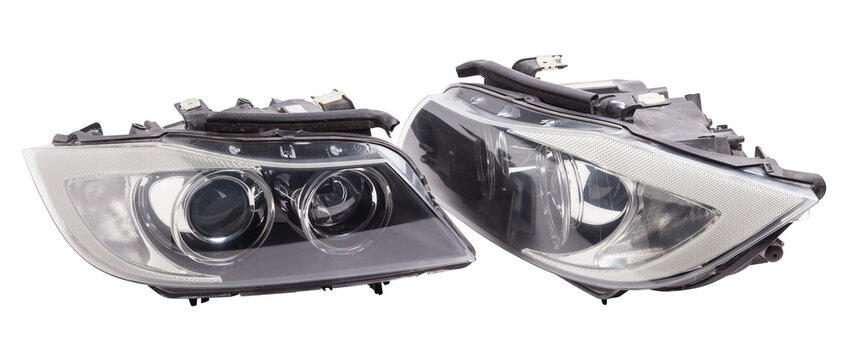 Stylish xenon headlight of a German car - optical equipment with a lamp inside on a white isolated background. Spare part for auto repair in a car workshop.