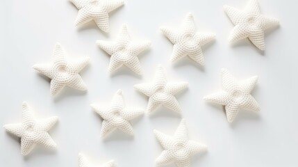 Knitted stars on a monochrome colored background, top view, with space for text. Greeting card, hobby, knitting, children's toy.